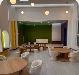 Open TALENTA.KIDS room arranged with child-sized tables and defined activity areas